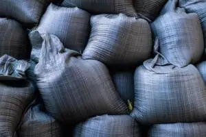 Close-up of stacked sandbags used for flood protection and emergency management.